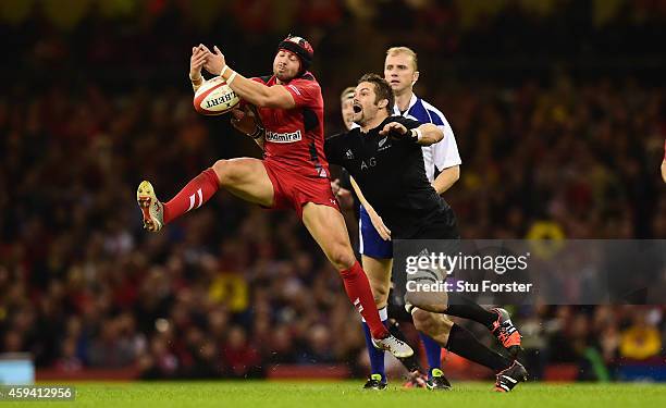 Wales fullback Leigh Halfpenny takes the high ball under pressure from Richie McCaw of New Zealand during the International match between Wales and...