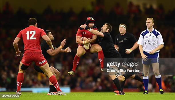 Wales fullback Leigh Halfpenny takes the high ball under pressure from Richie McCaw of New Zealand during the International match between Wales and...