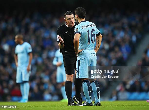 Referee Neil Swarbrick talks to Sergio Aguero of Manchester City during the Barclays Premier League match between Manchester City and Swansea City at...