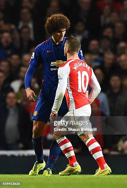 Marouane Fellaini of Manchester United and Jack Wilshere of Arsenal disagree during the Barclays Premier League match between Arsenal and Manchester...