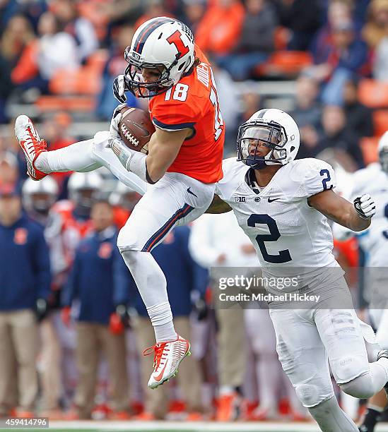 Mike Dudek of the Illinois Fighting Illini goes up to make a catch setting up a late second quarter touchdown as Marcus Allen of the Penn State...