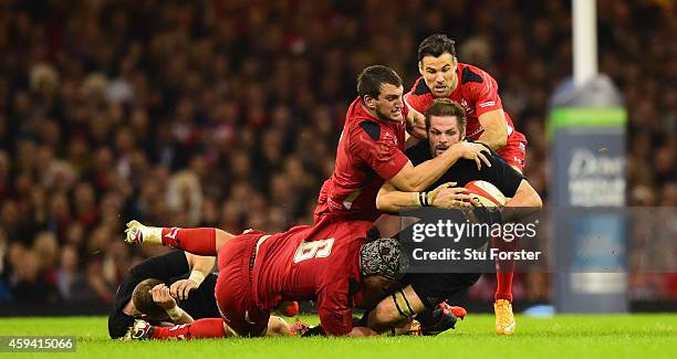 Wales captain Sam Warburton Dan Lydiate and Mike Phillips combine to thwart Richie McCaw of New Zealand during the International match between Wales...