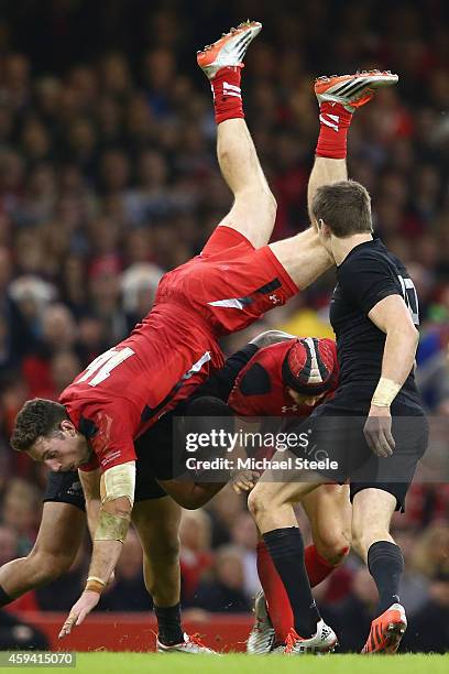 Alex Cuthbert of Wales lands awkwardly as Leigh Halfpenny gathers possession during the International match between Wales and New Zealand at the...