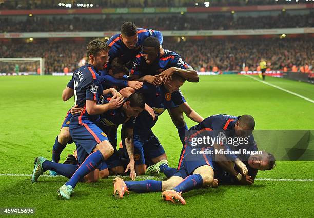 Wayne Rooney of Manchester United celebrates scoring his team's second goal with team mates during the Barclays Premier League match between Arsenal...