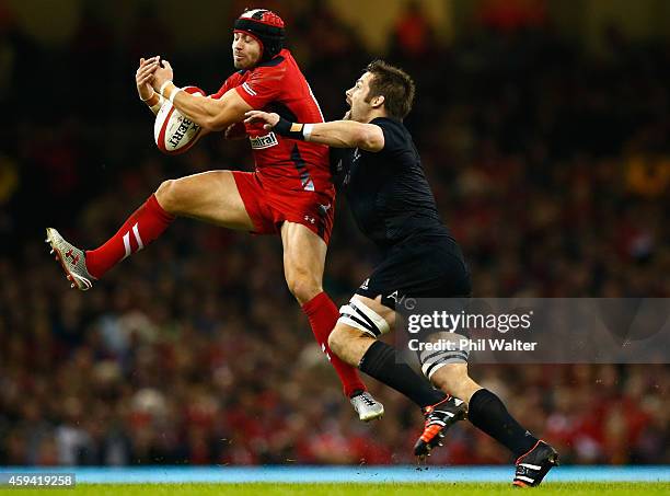 Leigh Halfpenny of Wales is tackled by Richie McCaw during the Intenational match between Wales and the New Zealand All Blacks at the Millennium...