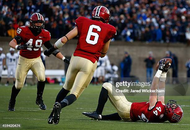 Scott Peters of the Harvard Crimson celebrates following his interception with 10 seconds remaining in the fourth quarter against the Yale Bulldogs...