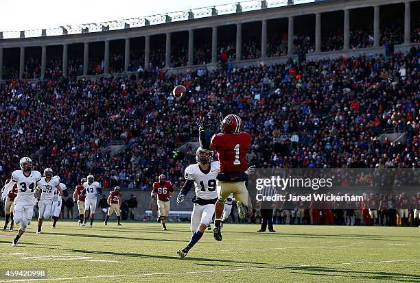 Andrew Fischer of the Harvard Crimson catches a pass in front of Jason Alessi of the Yale Bulldogs before running into the endzone for a touchdown...