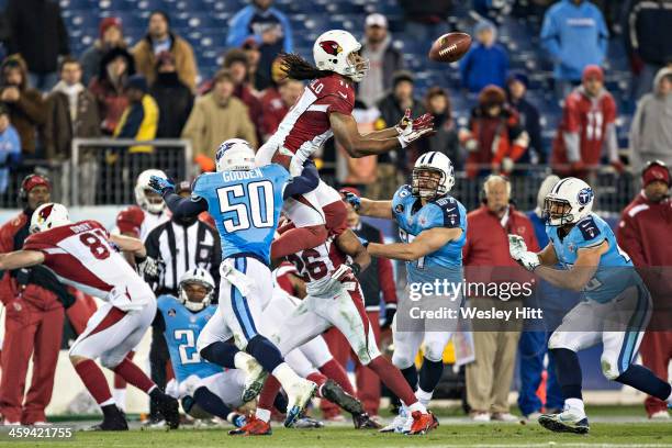 Larry Fitzgerald of the Arizona Cardinals jumps to get a on side kickoff but is hit and fumbles the ball against the Tennessee Titans at LP Field on...