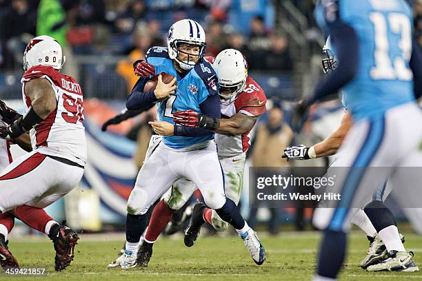 Ryan Fitzpatrick of the Tennessee Titans is hit from behind by Daryl Washington of the Arizona Cardinals at LP Field on December 15, 2013 in...