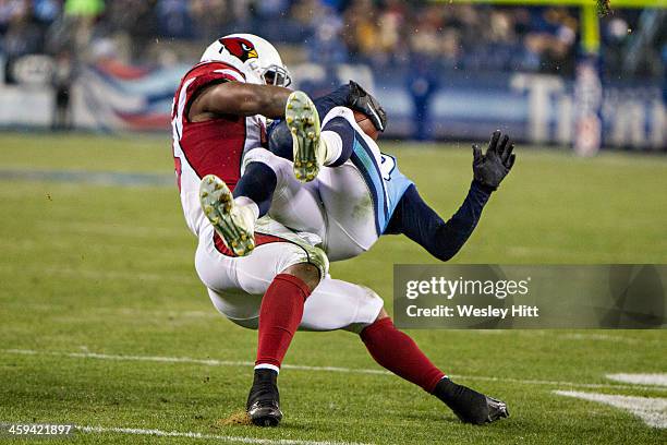 Kendall Wright of the Tennessee Titans is tackled by Daryl Washington of the Arizona Cardinals at LP Field on December 15, 2013 in Nashville,...