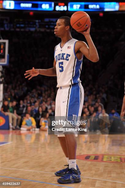 Rodney Hood of the Duke Blue Devils controls the ball against the UCLA Bruins during the CARQUEST Auto Parts Classic at Madison Square Garden on...