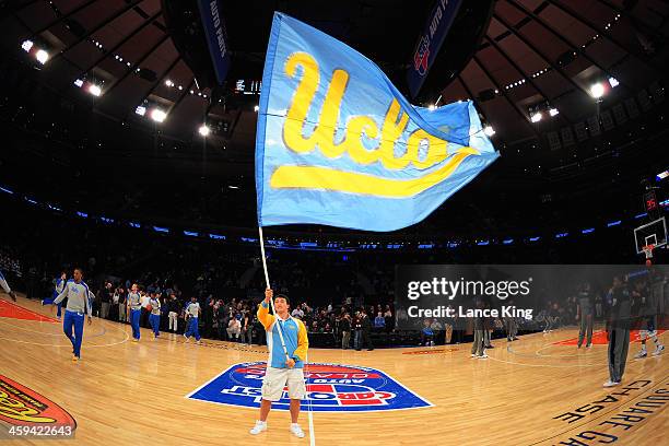 Cheerleader of the UCLA Bruins waves a flag against the Duke Blue Devils during the CARQUEST Auto Parts Classic at Madison Square Garden on December...