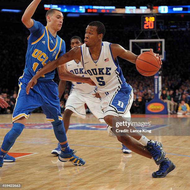 Rodney Hood of the Duke Blue Devils drives against Zach LaVine of the UCLA Bruins during the CARQUEST Auto Parts Classic at Madison Square Garden on...