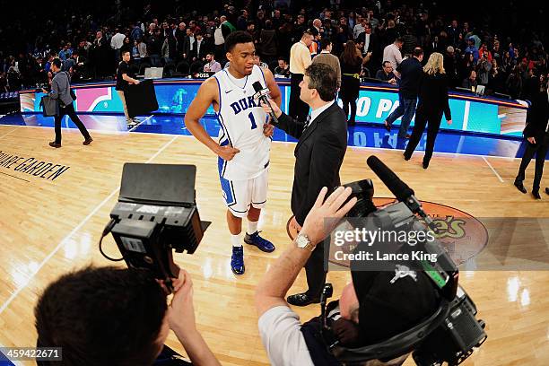 Analyst Andy Katz interviews Jabari Parker of the Duke Blue Devils against the UCLA Bruins during the CARQUEST Auto Parts Classic at Madison Square...