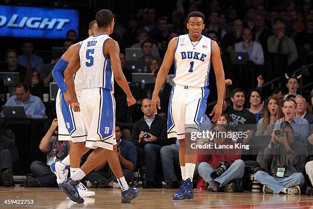 Josh Hairston, Rodney Hood and Jabari Parker of the Duke Blue Devils react following a play against the UCLA Bruins during the CARQUEST Auto Parts...