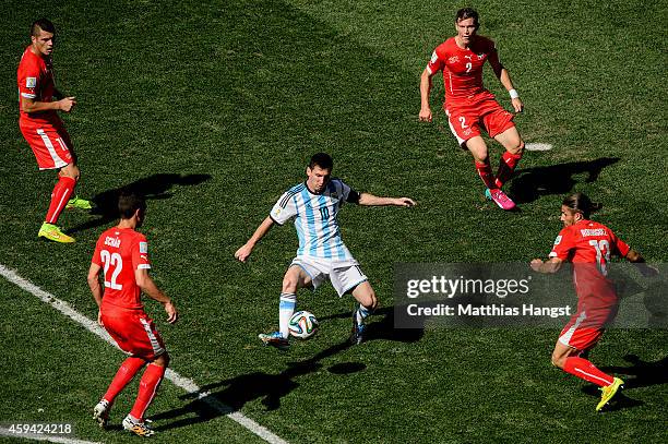 Lionel Messi of Argentina controls the ball against Josip Drmic , Fabian Schar , Stephan Lichtsteiner and Ricardo Rodriguez of Switzerland during the...