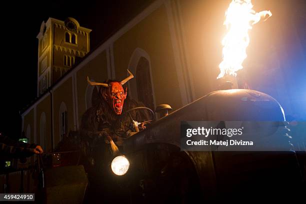 Participant dressed as the Krampus creature rides a tractor during Krampus gathering on November 22, 2014 in Schladming, Austria. Krampus is a...