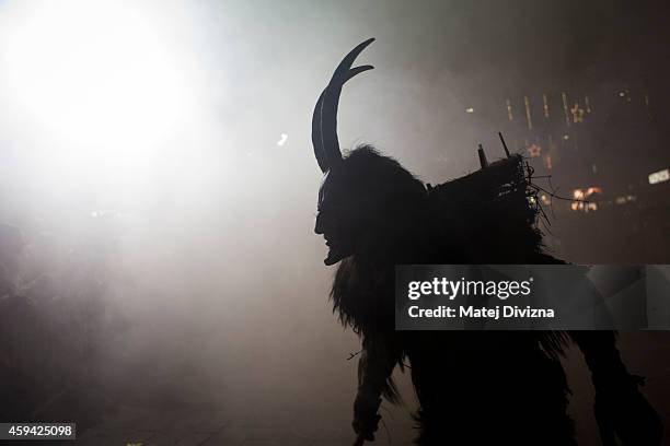 Participant dressed as the Krampus creature walks the streets during Krampus gathering on November 22, 2014 in Schladming, Austria. Krampus is a...
