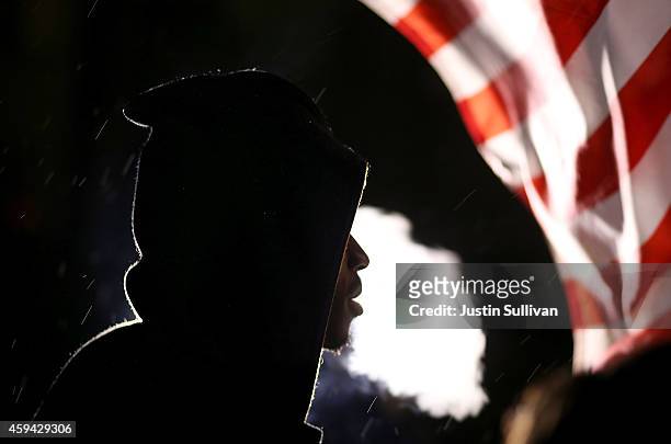Demonstrator protesting the shooting death of 18-year-old Michael Brown blows cigar smoke on November 22, 2014 in Ferguson, Missouri. Tensions in...