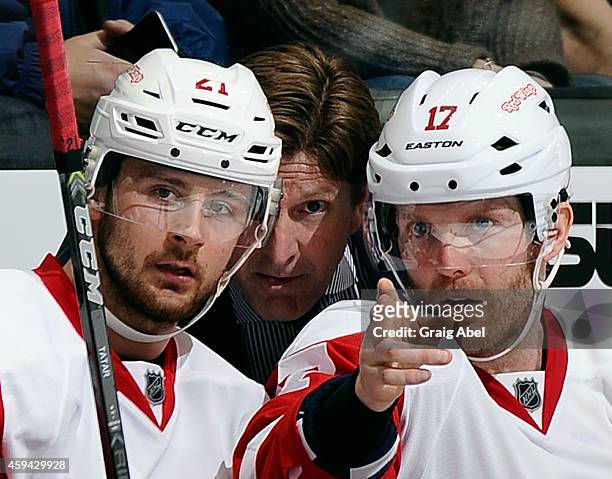 Tomas Tatar, Daniel Cleary and Coach Mike Babcock of the Detroit Red Wings talk during NHL game action against the Toronto Maple Leafs November 22,...