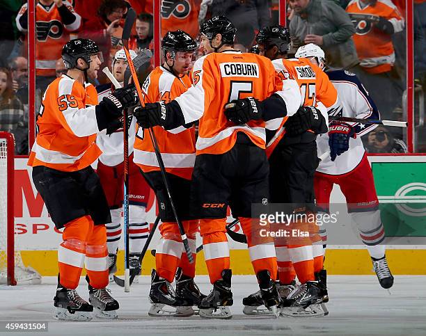 Braydon Coburn of the Philadelphia Flyers is congratulated by teammates Nick Schultz,Sean Couturier and Wayne Simmonds after Corburn scored a goal in...