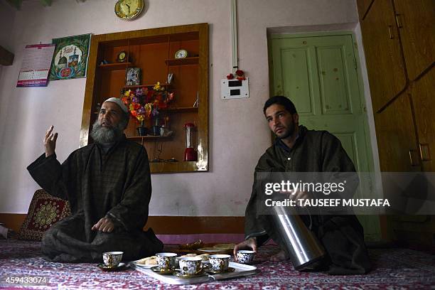 To go with India-Pakistan-Kashmir-election,FOCUS by Parvaiz Bukhari In this photograph taken on November 20 Kashmiri resident Muzaffar Ahmed Wani a...