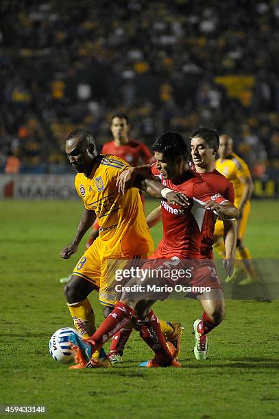 Joffre Guerron of Tigres fights for the ball with Francisco Gamboa of Toluca during a match between Tigres UANL and Toluca as part of 17th round...