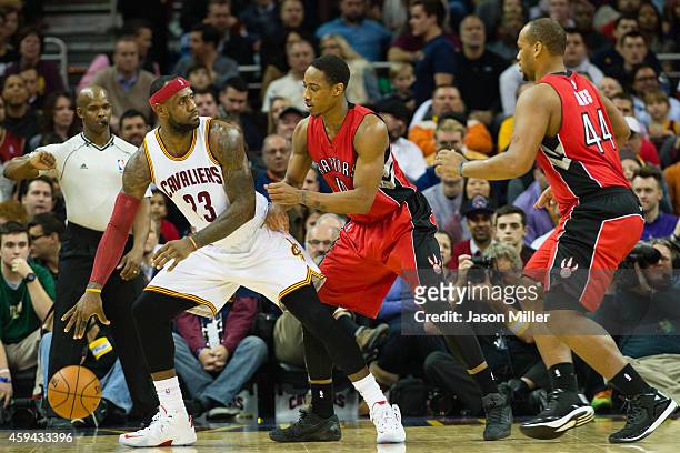 DeMar DeRozan and Chuck Hayes of the Toronto Raptors double team LeBron James of the Cleveland Cavaliers during the first half at Quicken Loans Arena...