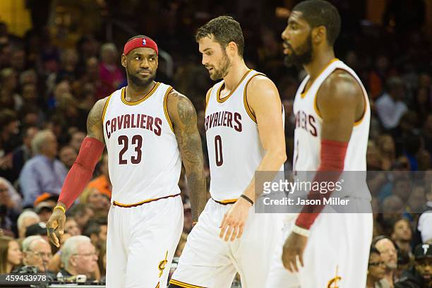 LeBron James Kevin Love and Kyrie Irving of the Cleveland Cavaliers walk off the court during a time out during the first half against the Toronto...