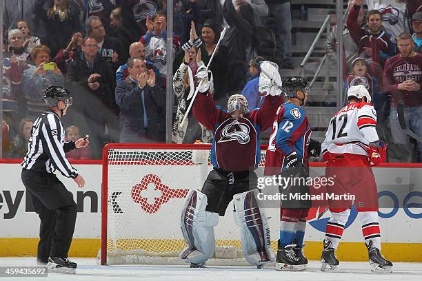 Goaltender Calvin Pickard of the Colorado Avalanche celebrates victory with teammate Jarome Iginla as Eric Staal of the Carolina Hurricanes reacts at...