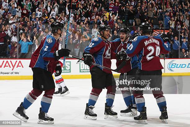 Jarome Iginla of the Colorado Avalanche celebrates with teammates Gabriel Landeskog, Nathan MacKinnon, and Nick Holden after scoring the game-tying...