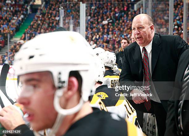 Head coach Claude Julien of the Boston Bruins looks on from the bench during their NHL game against the Vancouver Canucks at Rogers Arena December...