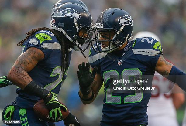 Cornerback Richard Sherman of the Seattle Seahawks celebrates with free safety Earl Thomas after making an interception against the Arizona Cardinals...