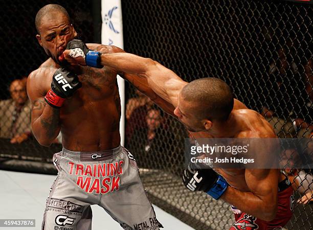 Edson Barboza of Brazil punches Bobby Green in their lightweight bout during the UFC Fight Night event at The Frank Erwin Center on November 22, 2014...