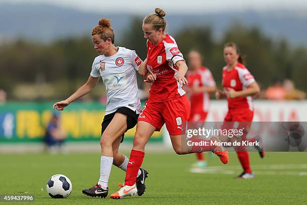 Dylan Holmes of Adelaide competes for the ball with Caitlin Jarvie of Western Sydney during the round 11 W-League match between Adelaide United and...