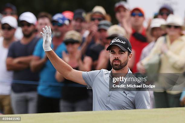 Nick Cullen of Australia reacts after chipping the ball out of the bunker on the 18th green during day four of the Australian Masters at The...