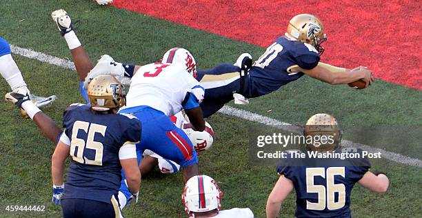 Good Counsels Andres Castillo dives in to score early in the third quarter against DeMatha in the Washington Catholic Athletic Conference football...