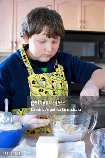 Boy, 12 years old, making cookies Boy, 12 years old, making cookies