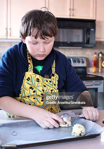 boy, 12 years old, making a chocolate chips cookie - 12 13 years ストックフォトと画像