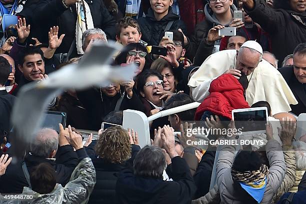 Pope Francis blesses a baby after a canonization mass for Euphrasia Eluvathingal, friar Francescano Amato Ronconi, bishop Antonio Farina, priest...