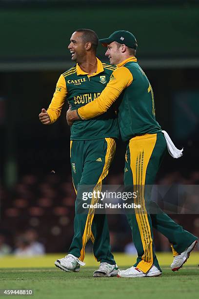 Robin Peterson of South Africa celebrates with David Miller of South Africa after taking the wicket of Matthew Wade of Australia during game five of...