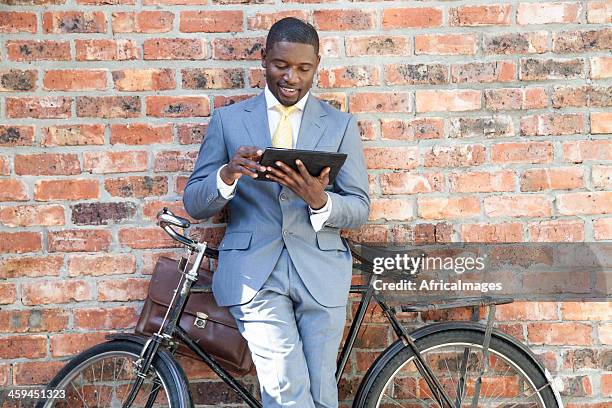 african businessman sitting on his bicycle. - cape town cbd stock pictures, royalty-free photos & images