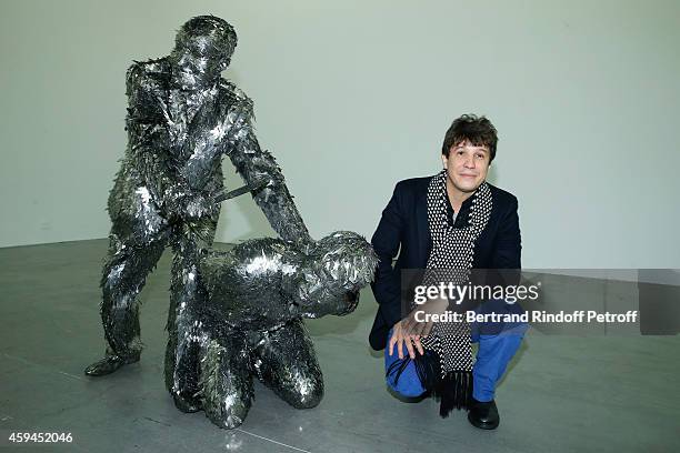 Contemporary artist Adel Abdessemed poses with his sculpture,a self-portrait representation of his beheading by his father during a closing party and...