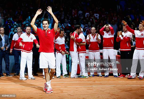 Roger Federer of Switzerland leads the celebrations after defeating Richard Gasquet of France as Stanislas Wawrinka of Switzerland , Marco...