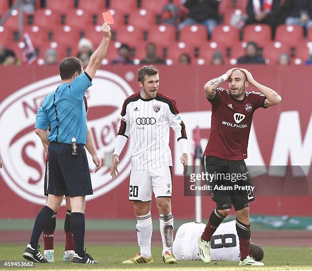 Javier Pinola of FC Nuernberg is shown a red card after fouling Bernardo De Oliveira of FC Ingolstadt during the 2. Bundesliga match between FC...