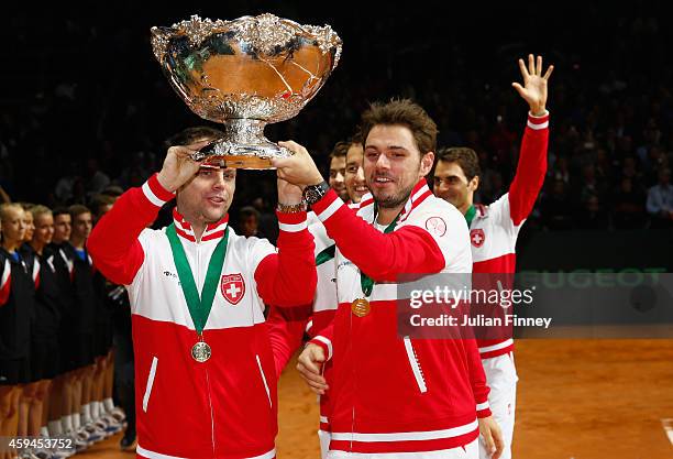 Stanislas Wawrinka of Switzerland and Captain Severin Luthi of Switzerland celebrate winning the Davis Cup against France during day three of the...