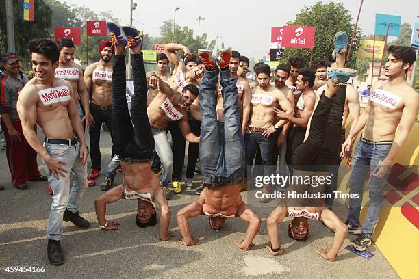 Male models promote Menshealth magazine during Airtel Delhi Half Marathon 2014 on November 23, 2014 in New Delhi, India.