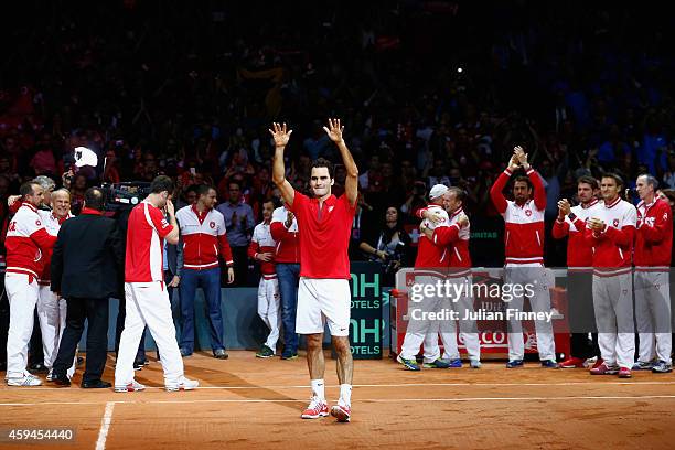 Roger Federer of Switzerland leads the celebrations after defeating Richard Gasquet of France as Stanislas Wawrinka of Switzerland , Marco...