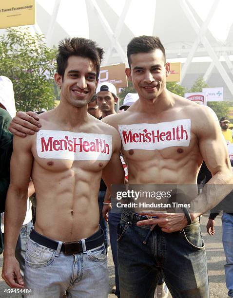 Male models promote Menshealth magazine during Airtel Delhi Half Marathon 2014 on November 23, 2014 in New Delhi, India.