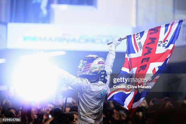 Lewis Hamilton of Great Britain and Mercedes GP celebrates in Parc Ferme after winning the World Championship and the Abu Dhabi Formula One Grand...